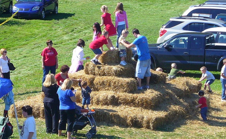 Climbing the hay bale tower at Apple Castle. Image courtesy of Apple Castle.